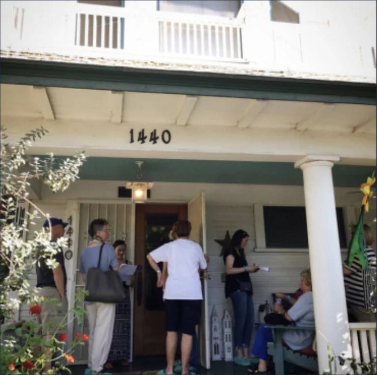 family at front doorstep of home